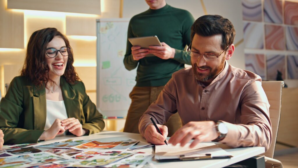 Business team signing deal in office boardroom - Home Builder Marketers